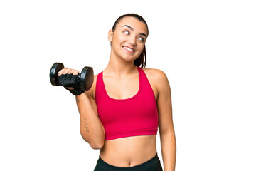 Young sport woman making weightlifting looking up while smiling