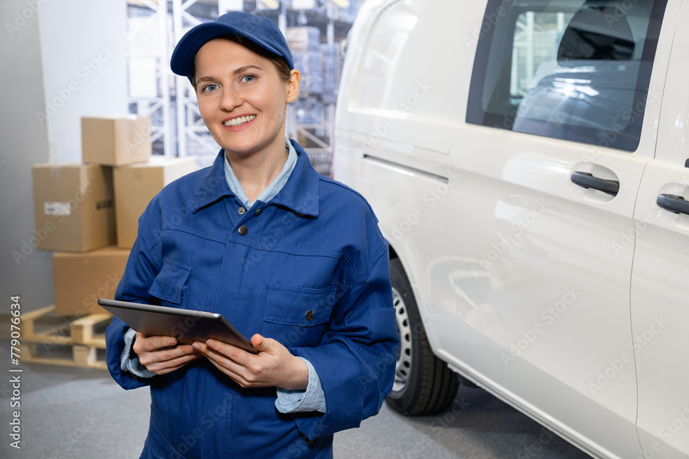 Poster manager with a digital tablet on the background of van. fleet and warehouse management..