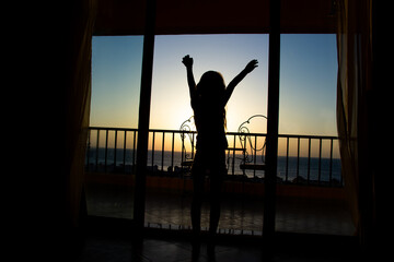 Happy children silhouette from room at sea travel