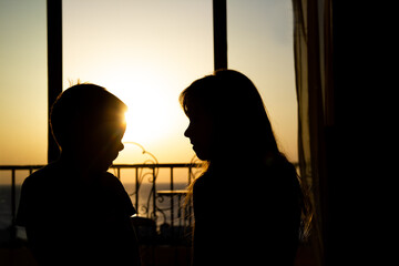 Happy children silhouette from room at sea travel