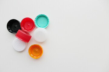 Plastic bottle caps on grey background, banner with copy space