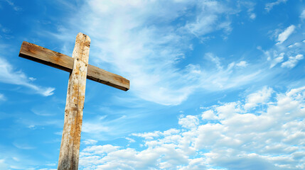 Silhouette of a wooden Christian cross against a blue sky with scattered clouds. Concept of Faith and Spirituality, Easter, Exaltation, religious holidays. Horizontal frame, copy space