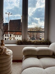 Part of the decoration in the interior, a vase and a view of the city from the window - obrazy, fototapety, plakaty