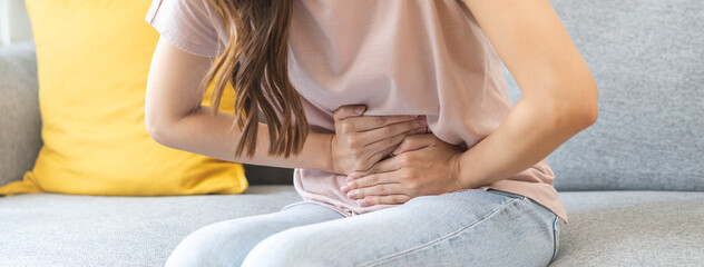 Flatulence asian young woman intolerance hand in stomach ache, suffer from food poisoning,...