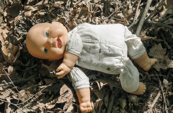 The doll abandoned in the forest. Baby doll thrown into the forest. 
