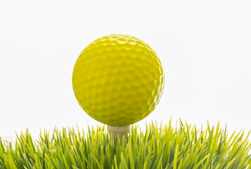 Close-up of a golf ball on tee on white background with copy space.