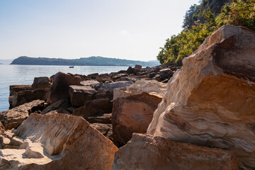 Panoramic view of idyllic coastline of Gulf of Piran, Adriatic Mediterranean Sea, Slovenia, Europe. Summer seaside vacation. Stroll along the tranquil stone beach of Fiesa. Shoreline Slovenian Istria