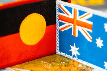 Aboriginal and Australian flag. Concept, common land. Settlers' responsibility towards the indigenous people of Australia, close up - 779109810