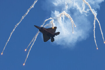 Bottom view of a F-22 Raptor deploying flares