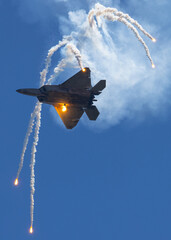 Bottom view of a F-22 Raptor deploying flares