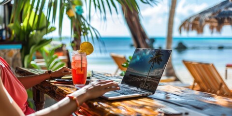 A freelancer typing on a laptop at a beachfront cafe with a tropical drink, epitomizing work flexibility and leisure in a workcation setting.