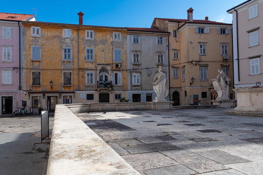 Scenic view of statues in Trg 1 maja square in coastal town Piran, Primorska, Slovenia, Europe. Marvel at exquisite statues against the backdrop of medieval residences. Exploring streets of old town