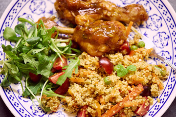 Couscous salad with Chicken breast and vegetables, tomatoes, bell pepper, mint, carrot and green beans with Chicken drumsticks baked in orange and honey marinade. Directly above.