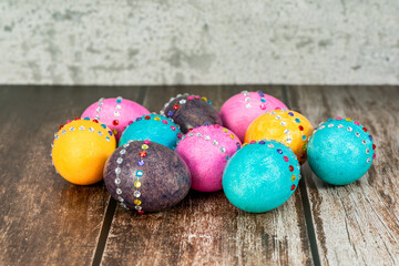 Decorated colorful Easter eggs on vintage wooden table