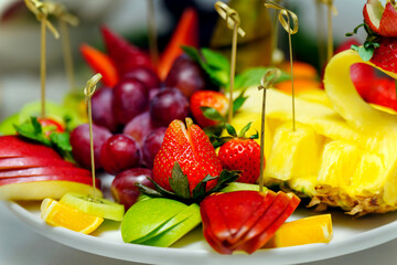 plate of exquisitely sliced fruits for guests