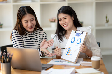 Two engaged businesswomen discussing a business report Share insights and ideas in the office, Remote work with virtual meeting presentation in office.
