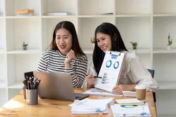 Two engaged businesswomen discussing a business report Share insights and ideas in the office, Remote work with virtual meeting presentation in office.