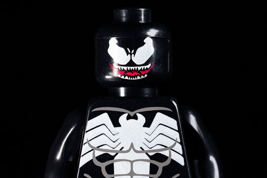 Face of LEGO Marvel Venom with scary teeth on a black background