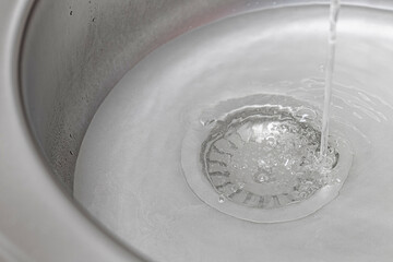 a sink with a closed drain hole is filled with water