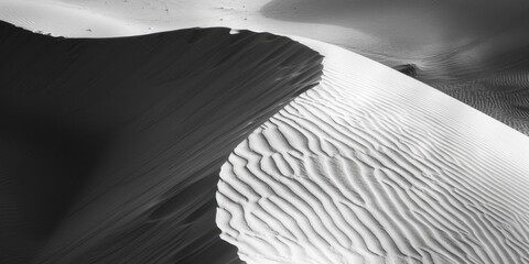 A striking black and white image of a sand dune, perfect for various design projects