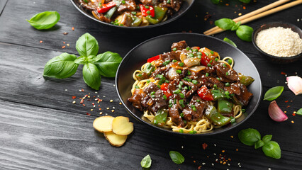 Stir fried beef in black bean sauce with vegetables and noodles. Take away food