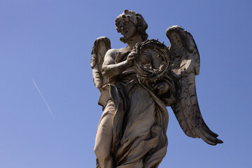 Monument of a Roman Angel during a sunny and warm day in summer in the city of Rome, Italy near the Saint Angelo Castle.