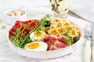 English breakfast. Boiled egg, jamon, waffles and green herbs. - 779142235