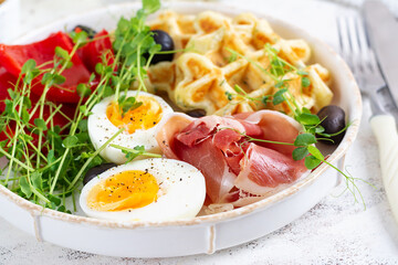 English breakfast. Boiled egg, jamon, waffles and green herbs. - 779142245
