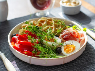 English breakfast. Boiled egg, jamon, waffles and green herbs. - 779142254