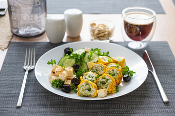 Healthy breakfast. Roll omelette, feta cheese and cucumber salad. Keto, ketogenic lunch. - 779142403