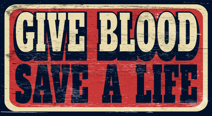 Aged and worn give blood save a life sign on wood