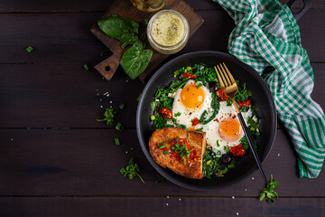 Keto breakfast. Fried eggs  with spinach and toast. Top view, flat lay - 779143251