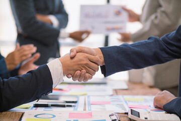 committee of businessmen and investors join hands as symbol of joint investment after discussing consulting and making contract  invest in business together. committee joins hands in meeting.