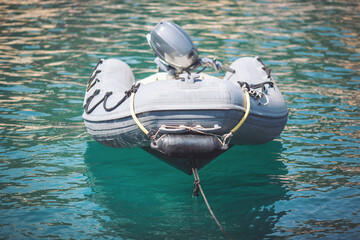 An Inflatable Boat in the sea, from the sun on a background of sea water. A Boat there is an oxygen...