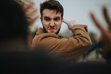 Young adult businessman showing aggression towards a colleague during an outdoor confrontation or...
