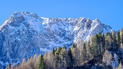 Panoramic view of Karawanks mountain range on sunny day in Carinthia, Austria. Looking at snow capped summit of Vertatscha and Hochstuhl. Remote high alpine landscape in Bodental, Austrian Alps - obrazy, fototapety, plakaty
