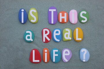 Is this a real life, social issue question composed with hand painted multi colored stone letters...