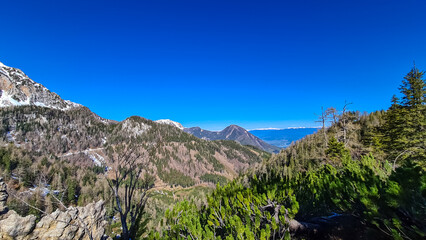 Panoramic view of Karawanks mountain range on sunny day in Carinthia, Austria. Looking at snow capped summit of Vertatscha and Hochstuhl. Remote high alpine landscape in Bodental, Austrian Alps