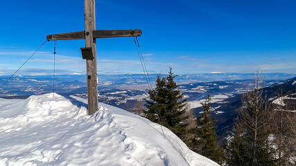Panoramic hiking trail trough deep snow leading to the mountain summit of Matschacher Gupf in...