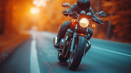 Motorcycle rider on the road at sunset. Biker in helmet on a motorcycle. - obrazy, fototapety, plakaty