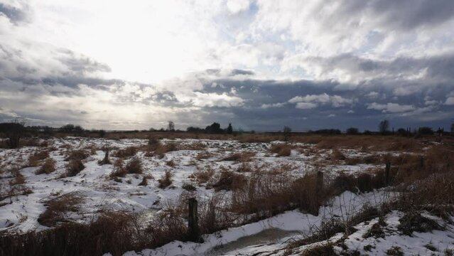 Winter Landscape with Snowy Field and Dramatic Cloudy Sky