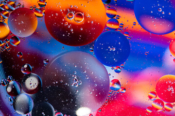 Macro photography of oil bubbles dissolved in water. Colorful background.
