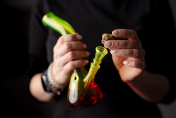 Woman Fills Bong With Cannabis Leaves, Detail Of Female Hand Preparing Marijuana For Use