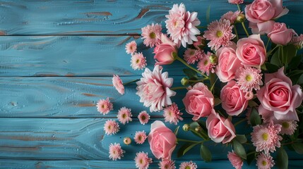 pink flowers on blue background, top view with copy space