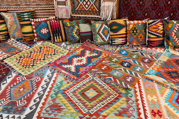 Woolen carpets and pillows with colorful oriental ornaments