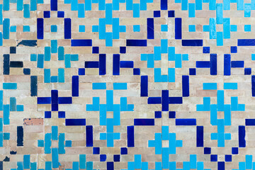 Ancient mosaic wall decoration with Arabic pattern, blue square tiling