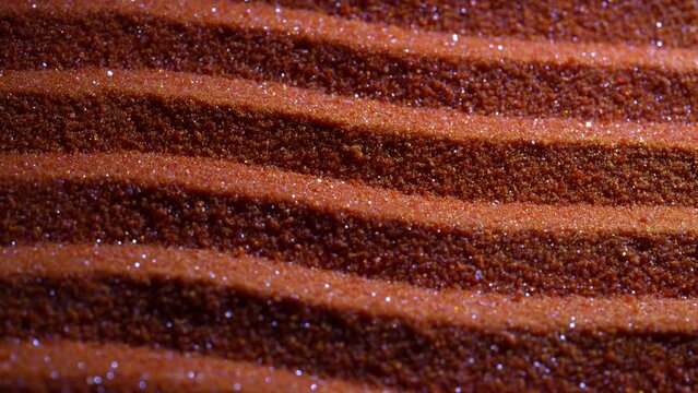 Small bright orange crystals of potassium dichromate, close up, abstract colorful background