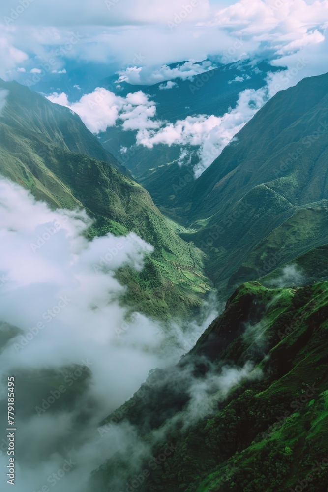 Poster A scenic view of a mountain range with clouds in the air. Suitable for various nature and travel concepts