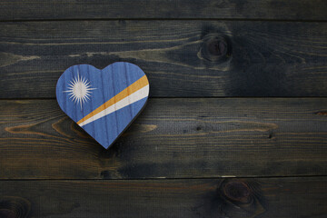 wooden heart with national flag of Marshall Islands on the wooden background.