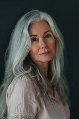A woman with grey hair wearing a pink shirt. Suitable for various lifestyle and fashion concepts